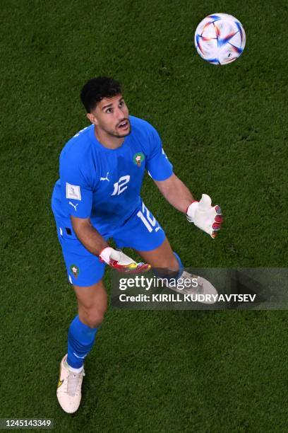 Morocco's goalkeeper Monir El Kajoui makes a save during the Qatar 2022 World Cup Group F football match between Belgium and Morocco at the...