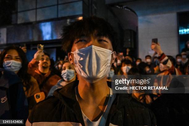 People gather on a street in Shanghai on November 27 where protests against China's zero-Covid policy took place the night before following a deadly...