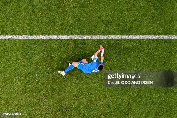 Morocco's goalkeeper Monir El Kajoui dives for the ball during the Qatar 2022 World Cup Group F football match between Belgium and Morocco at the...