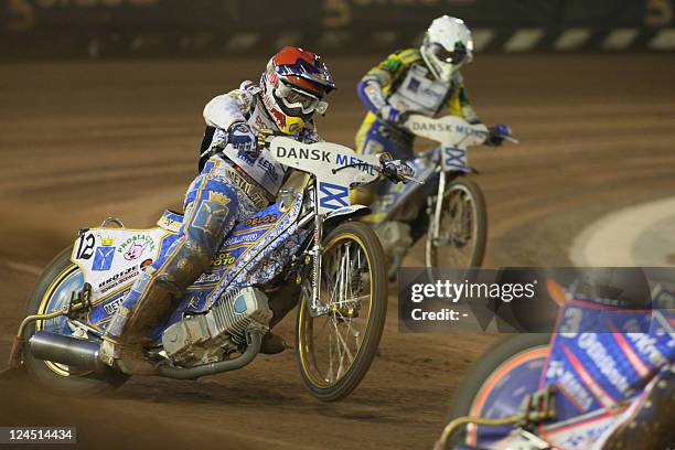 Russia's Emil Sayfutdinov and Poland's Tomasz Gollob compete during the FIM Speedway Grand Prix 2011 at Vojens' Speedway Center on September 10,...