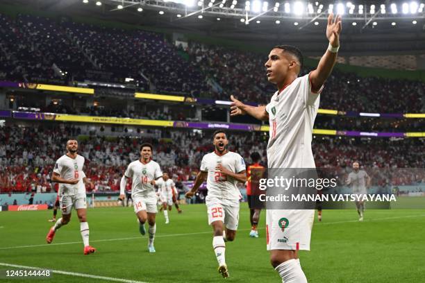 Morocco's midfielder Abdelhamid Sabiri celebrates with teammates after he scored his team's first goal during the Qatar 2022 World Cup Group F...