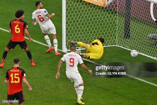 Belgium's goalkeeper Thibaut Courtois concedes a goal shot by Morocco's midfielder Abdelhamid Sabiri during the Qatar 2022 World Cup Group F football...