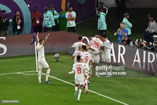 Morocco's midfielder Abdelhamid Sabiri celebrates teammates after he scored his team's first goal during the Qatar 2022 World Cup Group F football...