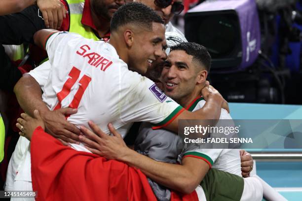 Morocco's defender Achraf Hakimi and midfielder Abdelhamid Sabiri are greeted at the end of the Qatar 2022 World Cup Group F football match between...