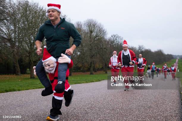 Fun runners dressed as Santa Claus take part in the 2022 Windsor Santa Dash on the Long Walk in Windsor Great Park in aid of the Alexander Devine...