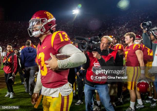 Trojans quarterback Caleb Williams carries the game ball as he leaves the field after beating Notre Dame at the Coliseum on November 26, 2022 in Los...