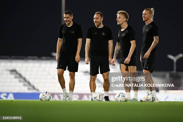 Denmark's midfielder Christian Eriksen takes part in a training session with teammates at Al Sailiya SC in Doha on November 27 during the Qatar 2022...