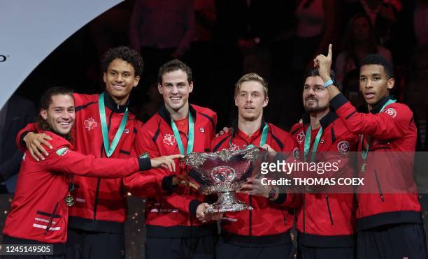 Canada's team holds the trophy after winning the Davis Cup tennis tournament at the Martin Carpena sportshall, in Malaga on November 27, 2022. -...