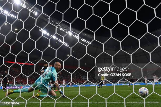 Canada's goalkeeper Milan Borjan concedes the third goal scored by Croatia's forward Andrej Kramaric during the Qatar 2022 World Cup Group F football...