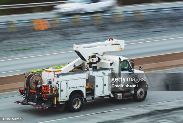 power utility truck en route - truck stock pictures, royalty-free photos & images