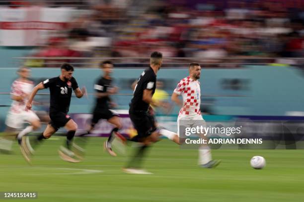 Croatia's midfielder Mateo Kovacic runs with the ball during the Qatar 2022 World Cup Group F football match between Croatia and Canada at the...