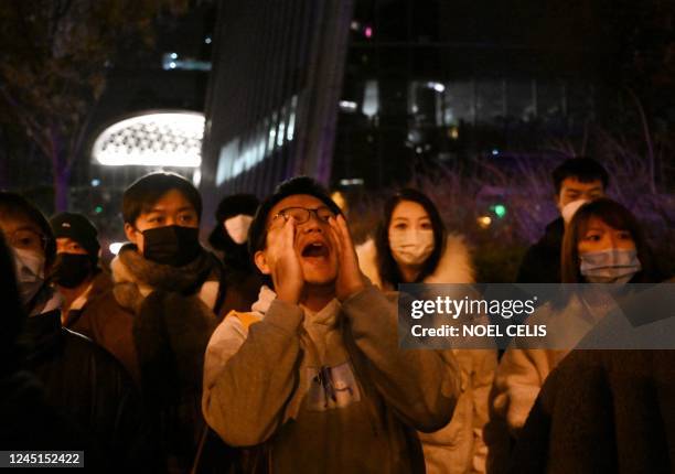 Protester shouts during a protest for the victims of a deadly fire as well as a protest against China's harsh Covid-19 restrictions in Beijing on...