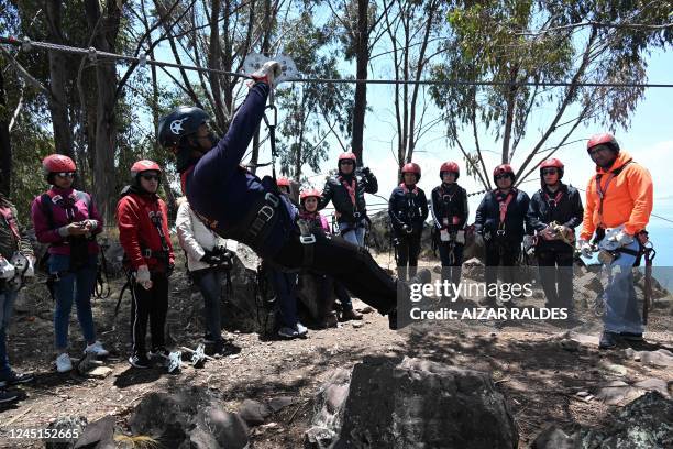 Tourists receive instructions before sliding down one of the world's most extended zip lines over the Tiquina Strait in Lake Titicaca, Bolivia, on...