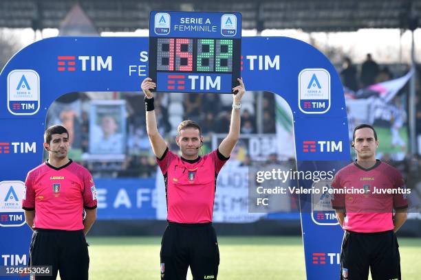 The referee raises the overhead projector displaying the number 1522, a toll-free number for anti-violence and stalking purposes during the match...