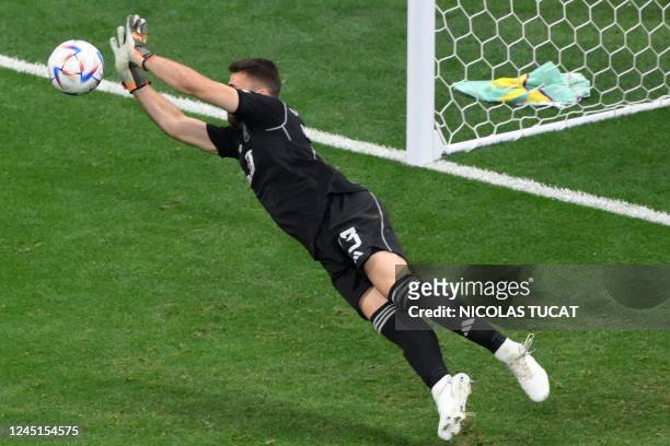 Spain's goalkeeper Unai Simon deflects a shot by Germany's midfielder Joshua Kimmich during the Qatar 2022 World Cup Group E football match between...