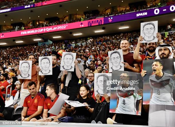 Fans hold photos and posters of Mesut Ozil of Medipol Basaksehir during the FIFA World Cup Qatar 2022 Group E match between Spain and Germany at Al...