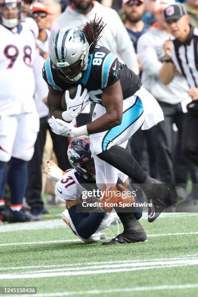 Carolina Panthers tight end Ian Thomas is tackled by Denver Broncos free safety Justin Simmons during an NFL football game between the Denver Broncos...
