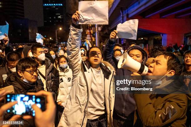 Demonstrators hold blank signs and chant slogans during a protest in Beijing, China, on Monday, Nov. 28, 2022. Protests against Covid restrictions...