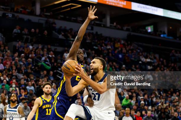 Rudy Gobert of the Minnesota Timberwolves drives to the basket against Draymond Green of the Golden State Warriors in the fourth quarter at Target...