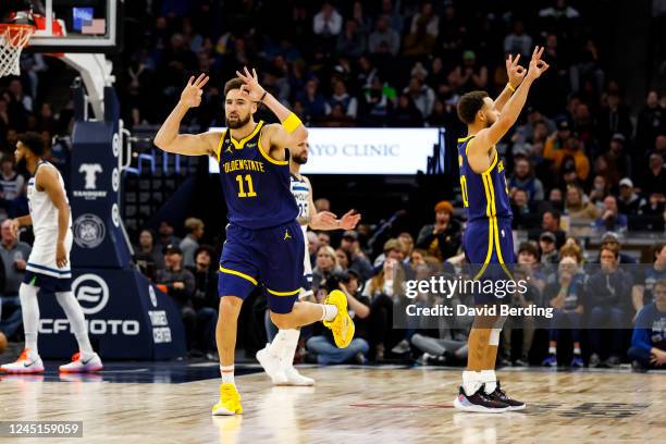 Klay Thompson and Stephen Curry of the Golden State Warriors celebrate a three-point basket by Thompson against the Minnesota Timberwolves in the...