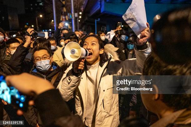 Demonstrator holds a blank sign and chants slogans during a protest in Beijing, China, on Monday, Nov. 28, 2022. Protests against Covid restrictions...