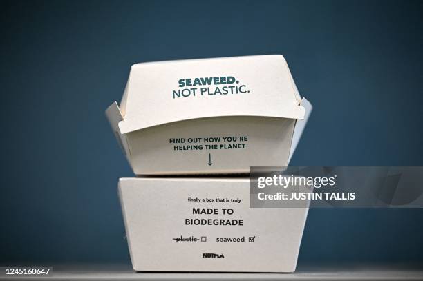 In this arranged photograph takeaway food packaging with "Notpla Coating" is pictured at Notpla in Hackney, east London, on November 24, 2022. - A...