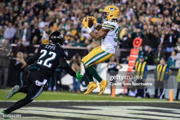 Green Bay Packers running back Aaron Jones catches a pass for a touchdown during the first half of the National Football League game between the...