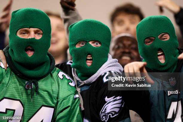 Masked Philadelphia Eagles fans cheer during the third quarter of an NFL football game against the Green Bay Packers at Lincoln Financial Field on...