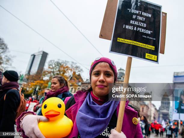 Woman is seen holding a placard with a testimony of violence during the demonstration. For the sixth consecutive year, the civil society associations...