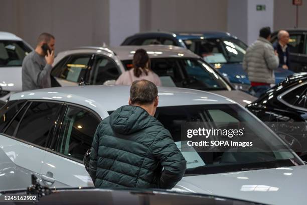 Visitors to the used car show are seen examining the conditions of purchase of used vehicles on show at the event.. The second-hand used vehicle fair...