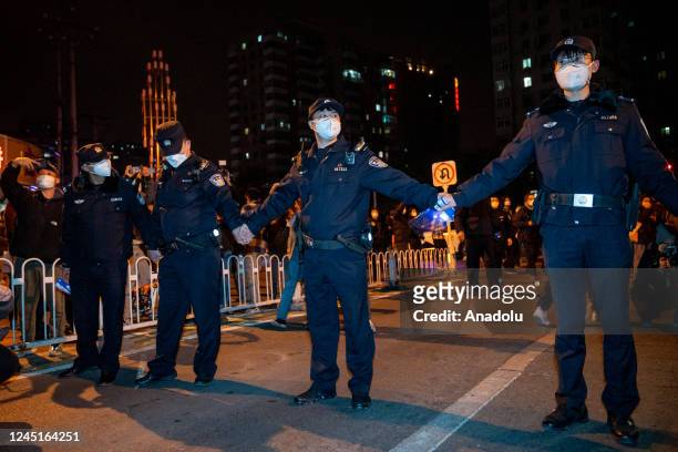 Police officers stand guard during a protest again Zero Covid and epidemic prevention restrictions in Beijing, China, on Sunday, November 27, 2022.