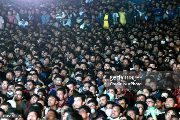 Football fans watch the Qatar 2022 World Cup football match between Argentina and Mexico on a big screen at the Dhaka University area in Dhaka,...