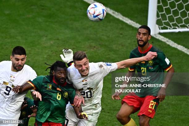 Serbia's forward Aleksandar Mitrovic, Cameroon's midfielder Andre-Frank Zambo Anguissa and Serbia's midfielder Sergej Milinkovic-Savic head the ball...