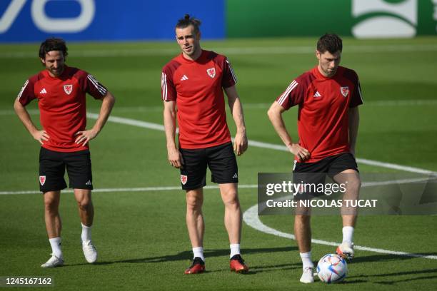 Wales' midfielder Joe Allen, Wales' forward Gareth Bale, and Wales' defender Ben Davies take part in a training session at the Al Saad SC in Doha on...