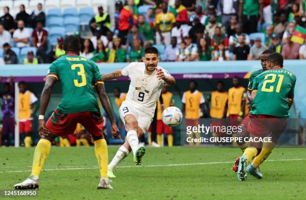 Serbia's forward Aleksandar Mitrovic fights for the ball with Cameroon's defender Jean-Charles Castelletto and Cameroon's defender Nicolas Nkoulou...