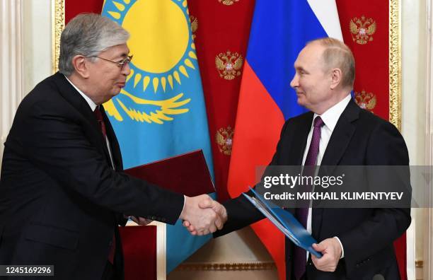 Russian President Vladimir Putin shakes hand with his Kazakhstan's counterpart Kassym-Jomart Tokayev after a signing ceremony in the Kremlin in...