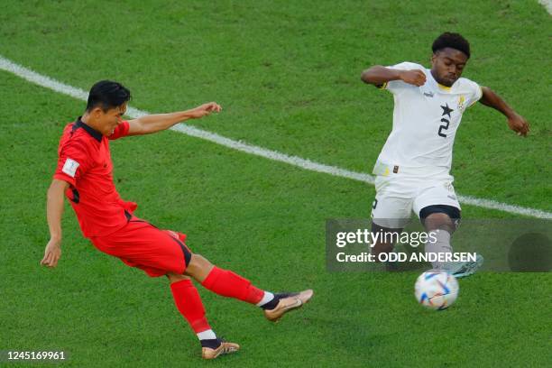 South Korea's midfielder Jeong Woo-yeong fights for the ball with Ghana's defender Tariq Lamptey during the Qatar 2022 World Cup Group H football...