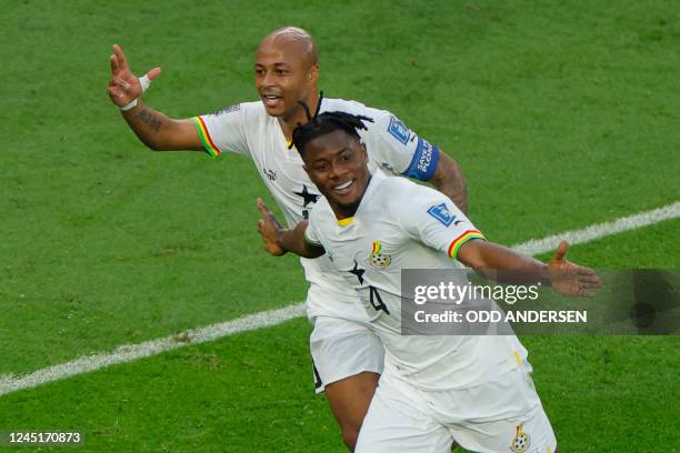 Ghana's defender Mohammed Salisu celebrates scoring his team's first goal with Ghana's midfielder Andre Ayew during the Qatar 2022 World Cup Group H...