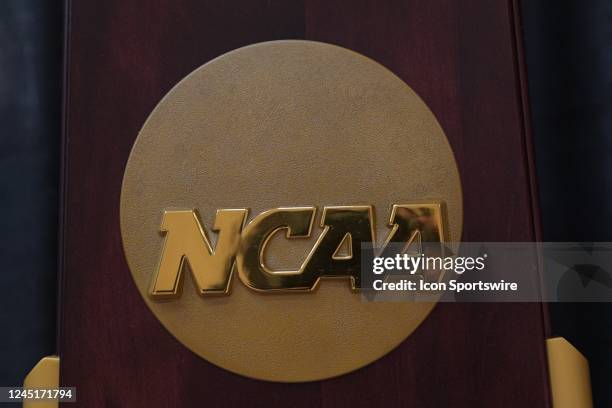 The NCAA logo on the 2023 Division I Men's Basketball National Championship trophy on display prior to a college basketball game between the Maine...