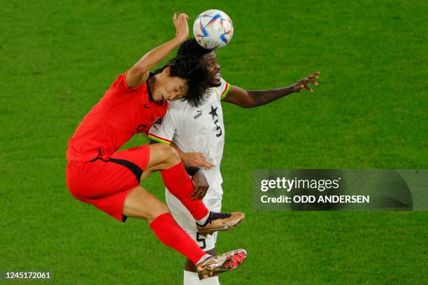 South Korea's forward Cho Gue-sung fights for the ball with Ghana's midfielder Thomas Partey during the Qatar 2022 World Cup Group H football match...