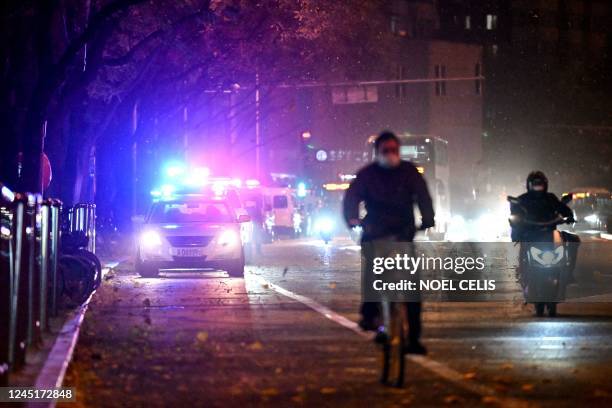 Police vehicles are pictured along a street in Beijing on November 28, 2022.