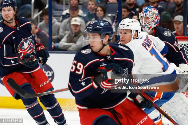 New York Islanders left wing Zach Parise between Columbus Blue Jackets right wing Yegor Chinakhov and goaltender Joonas Korpisalo during the second...