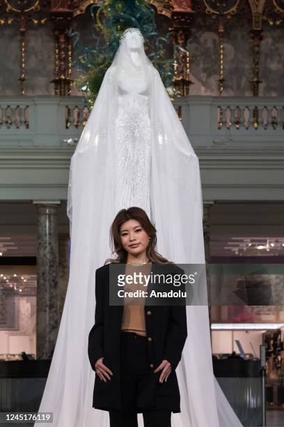 London based Korean fashion designer Miss Sohee poses for a photo in front of the Christmas tree she designed, in a forms of 3.5 metre couture gown...