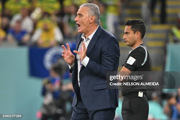 Brazil's coach Tite shouts instructions to his players from the touchline during the Qatar 2022 World Cup Group G football match between Brazil and...