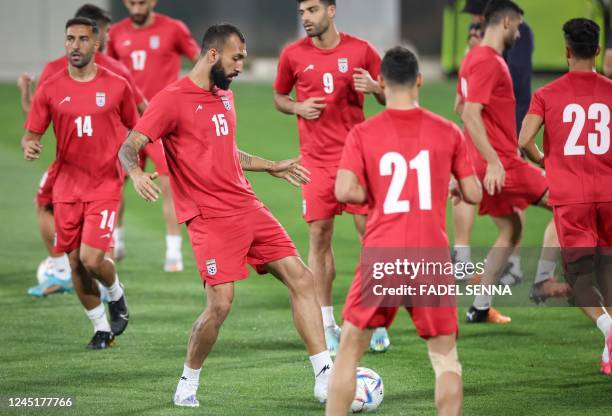 Iran's defender Roozbeh Cheshmi and teammates attend a training session at Al Rayyan SC in the Al Rayyan district in Doha on November 28 on the eve...