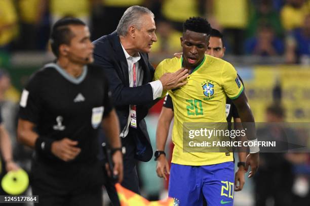 Brazil's forward Vinicius Junior reacts next to Brazil's coach Tite after his goal was disallowed during the Qatar 2022 World Cup Group G football...