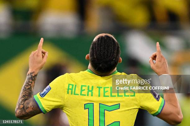 Brazil's defender Alex Telles celebrates after Brazil won the Qatar 2022 World Cup Group G football match between Brazil and Switzerland at Stadium...