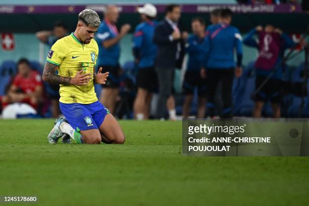 Brazil's midfielder Bruno Guimaraes prays after Brazil won the Qatar 2022 World Cup Group G football match between Brazil and Switzerland at Stadium...