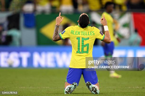 Brazil's defender Alex Telles celebrates after Brazil won the Qatar 2022 World Cup Group G football match between Brazil and Switzerland at Stadium...