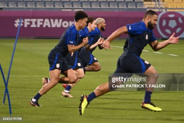 S players attend a training session at Al Gharafa SC in Doha on November 28 on the eve of the Qatar 2022 World Cup football match between Iran and...